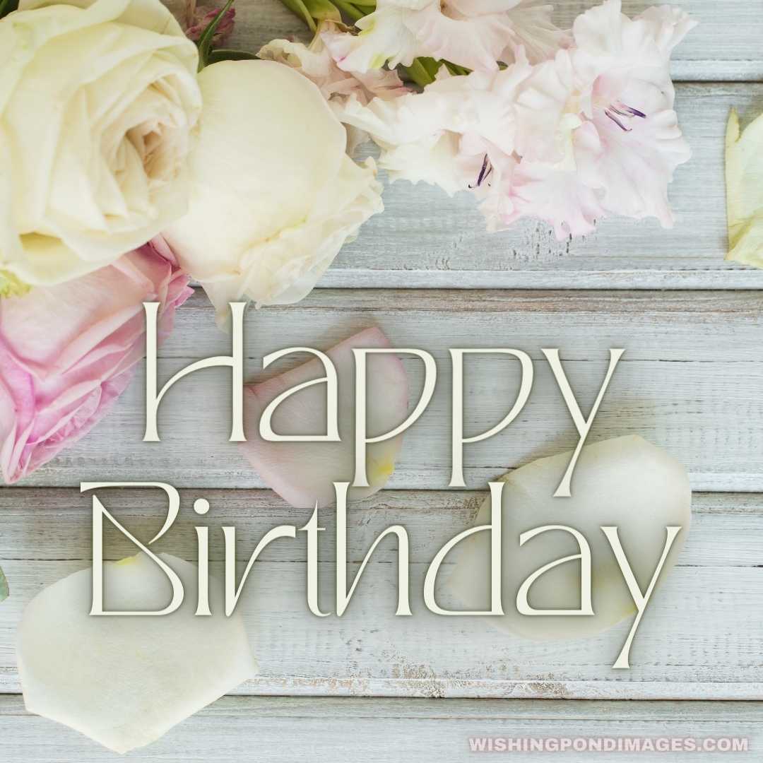 White and pink roses flowers on white painted wooden background - Happy Birthday Flower Images